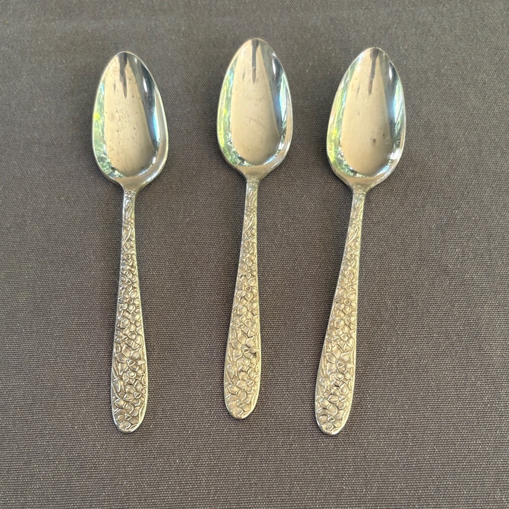Set of three Narcissus pattern silver teaspoons by National Silver